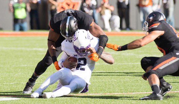Nov 7, 2015; Stillwater, OK, USA; TCU Horned Frogs quarterback Trevone Boykin (2) tackled by Oklahoma State Cowboys defensive end Emmanuel Ogbah (38) during the first quarter at Boone Pickens Stadium. Mandatory Credit: Rob Ferguson-USA TODAY Sports