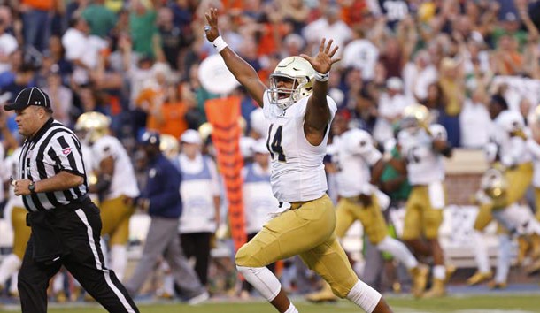 Sep 12, 2015; Charlottesville, VA, USA; Notre Dame Fighting Irish quarterback DeShone Kizer (14) celebrates after throwing the game-winning touchdown pass against the Virginia Cavaliers with twelve seconds left in the fourth quarter at Scott Stadium. The Fighting Irish won 34-27. Mandatory Credit: Geoff Burke-USA TODAY Sports