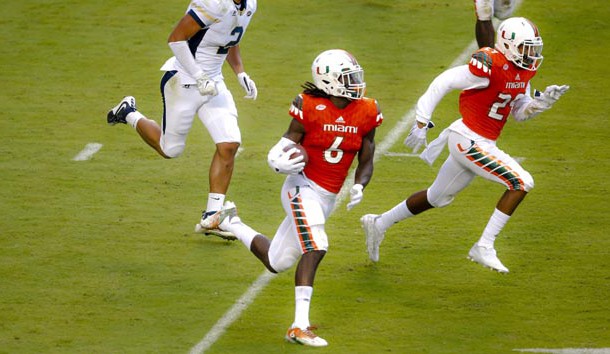 Nov 21, 2015; Miami Gardens, FL, USA; Miami Hurricanes defensive back Jamal Carter (6) carries the ball after making an interception against the Georgia Tech Yellow Jackets during the second half at Sun Life Stadium. Mandatory Credit: Steve Mitchell-USA TODAY Sports