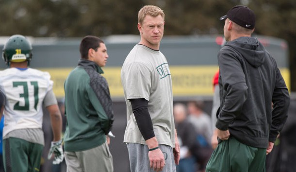 Jan 10, 2015; Euless, TX, USA; Oregon Ducks offensive coordinator Scott Frost (left) and head coach Mark Helfrich (right) watch their team during practice at the Euless Trinity High School football field. Mandatory Credit: Jerome Miron-USA TODAY Sports