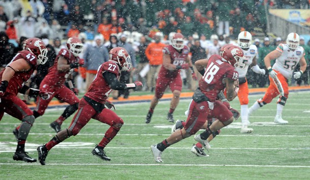 Dec 26, 2015; El Paso, TX, USA; Washington State Cougars safety Shalom Luani (18) returns an interception against the Miami Hurricanes during the second half at Sun Bowl Stadium. The Cougars won 20-14. Mandatory Credit: Joe Camporeale-USA TODAY Sports