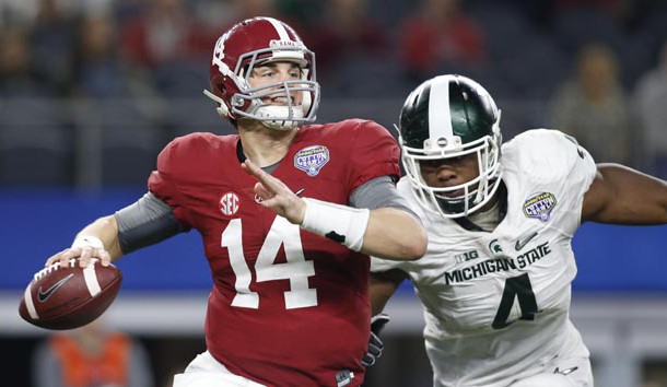 Dec 31, 2015; Arlington, TX, USA; Alabama Crimson Tide quarterback Jake Coker (14) is pressured by Michigan State Spartans defensive lineman Malik McDowell (4) in the third quarter in the 2015 CFP semifinal at the Cotton Bowl at AT&T Stadium. Mandatory Credit: Tim Heitman-USA TODAY Sports