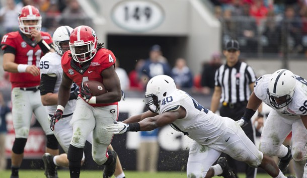 Jan 2, 2016; Jacksonville, FL, USA; Georgia Bulldogs running back Keith Marshall (4) runs for a first down as Penn State Nittany Lions linebacker Jason Cabinda (40) defends in the fourth quarter at EverBank Field. Georgia defeated Penn State 24-17 to win the 2016 TaxSlayer Bowl. Mandatory Credit: Logan Bowles-USA TODAY Sports