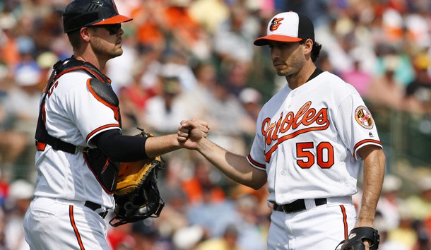 Mar 8, 2016; Sarasota, FL, USA;  Baltimore Orioles starting pitcher Miguel Gonzalez (50) fist pumps with catcher Matt Wieters (32) as he is taken out of the game during the third inning against the Boston Red Sox at Ed Smith Stadium. Mandatory Credit: Kim Klement-USA TODAY Sports