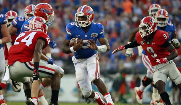 Oct 31, 2015; Jacksonville, FL, USA; Florida Gators quarterback Treon Harris (3) runs with the ball as Georgia Bulldogs safety Dominick Sanders (24) and cornerback Reggie Wilkerson (9) defends during the second half at  EverBank Stadium. Florida Gators defeated the Georgia Bulldogs 27-3. Photo Credit: Kim Klement-USA TODAY Sports