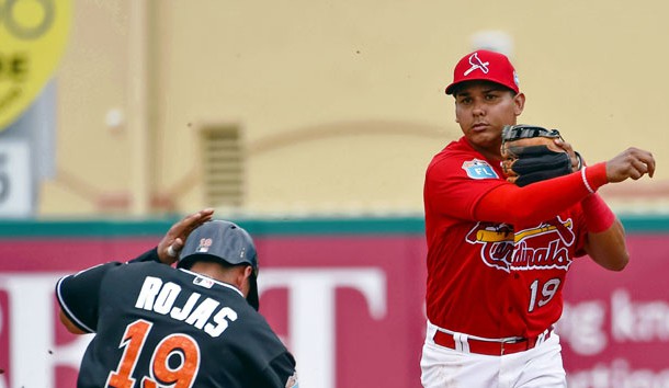 Mar 20, 2016; Jupiter, FL, USA; St. Louis Cardinals shortstop Ruben Tejada (19) turns a double play over Miami Marlins shortstop Miguel Rojas (19) during the game at Roger Dean Stadium. The Marlins defeated the Cardinals 5-2. Mandatory Credit: Scott Rovak-USA TODAY Sports