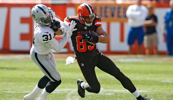 Sep 27, 2015; Cleveland, OH, USA;  Cleveland Browns wide receiver Brian Hartline (83) stiff arms Oakland Raiders defensive back Neiko Thorpe (31) during the first quarter at FirstEnergy Stadium. Mandatory Credit: Scott R. Galvin-USA TODAY Sports