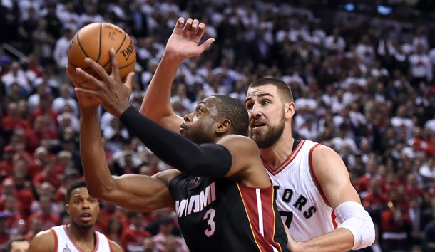 May 3, 2016; Toronto, Ontario, CAN;   Miami Heat guard Dwyane Wade (3) shoots past Toronto Raptors guard Jonas Valanciunas (17) in game one of the second round of the NBA Playoffs at Air Canada Centre. The Heat won 102 -96 in overtime. Photo Credit: Dan Hamilton-USA TODAY Sports