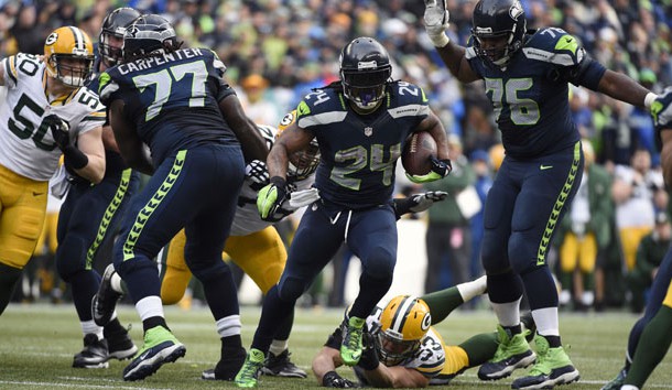 January 18, 2015; Seattle, WA, USA; Seattle Seahawks running back Marshawn Lynch (24) runs the ball ahead of  Green Bay Packers outside linebacker Nick Perry (53) during the second half in the NFC Championship game at CenturyLink Field. Mandatory Credit: Kyle Terada-USA TODAY Sports
