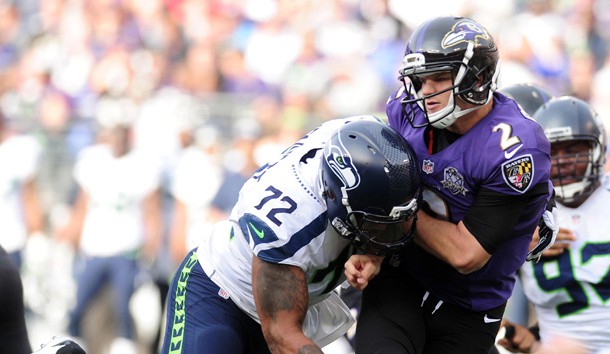 Dec 13, 2015; Baltimore, MD, USA; Baltimore Ravens quarterback Jimmy Clausen (2) is pressured by Seattle Seahawks defensive end Michael Bennett (72) in the second quarter at M&T Bank Stadium. Mandatory Credit: Evan Habeeb-USA TODAY Sports