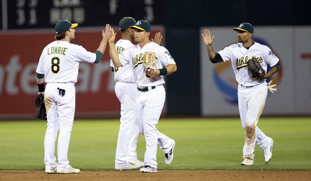 Jun 21, 2016; Oakland, CA, USA; Oakland Athletics second baseman Jed Lowrie (8), right fielder Jake Smolinski (5), center fielder Coco Crisp (4) and shortstop Marcus Semien (10) high five each other at the end of the game against the Milwaukee Brewers at the Oakland Coliseum the Oakland Athletics defeated the Milwaukee Brewers 5 to 3. Photo Credit: Neville E. Guard-USA TODAY Sports