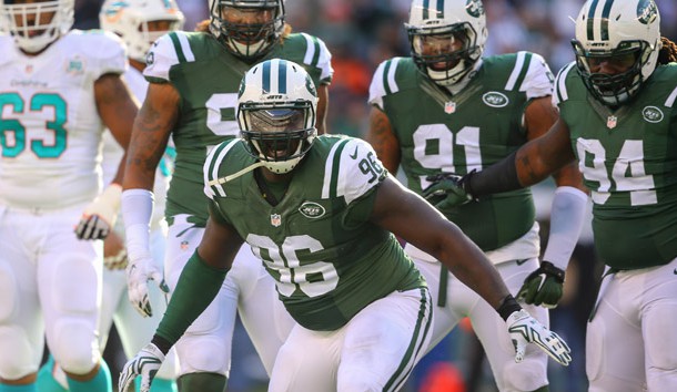 Nov 29, 2015; East Rutherford, NJ, USA; New York Jets defensive end Muhammad Wilkerson (96) celebrates his sack of Miami Dolphins quarterback Ryan Tannehill (not shown) during the first half at MetLife Stadium. Mandatory Credit: Ed Mulholland-USA TODAY Sports