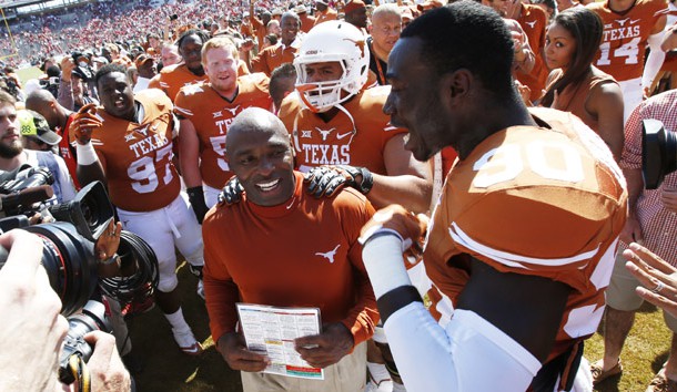 Charlie Strong is surrounded by his players after the game against the Oklahoma Sooners during the Red River rivalry at Cotton Bowl Stadium last year. Texas won 24-17. Photo Credit: Tim Heitman-USA TODAY Sports