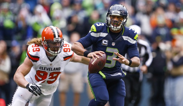Dec 20, 2015; Seattle, WA, USA; Seattle Seahawks quarterback Russell Wilson (3) escapes from pressure brought by Cleveland Browns outside linebacker Paul Kruger (99) during the first quarter at CenturyLink Field. Photo Credit: Joe Nicholson-USA TODAY Sports