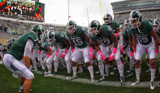 Tyler O'Connor (7) leads his team onto the field prior to a game against the Indiana Hoosiers at Spartan Stadium. O'Conner will take over the starting QB role. Photo Credit: Mike Carter-USA TODAY Sports