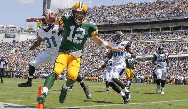 Sep 11, 2016; Jacksonville, FL, USA;Green Bay Packers quarterback Aaron Rodgers (12) runs the ball in for a touchdown as Jacksonville Jaguars cornerback Davon House (31) attempted to defend during the first quarter at EverBank Field. Photo Credit: Kim Klement-USA TODAY Sports