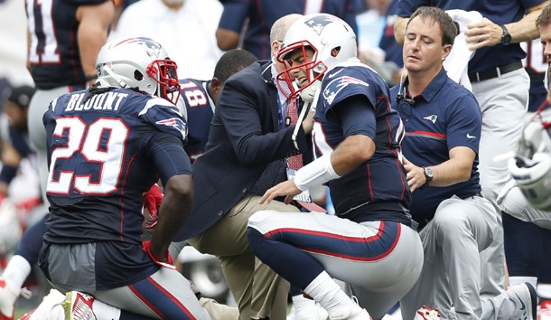 Sep 18, 2016; Foxborough, MA, USA; New England Patriots quarterback Jimmy Garoppolo (10) grimaces while being looked at by medical staff after being injured during the second quarter against the Miami Dolphins at Gillette Stadium. Photo Credit: Greg M. Cooper-USA TODAY Sports