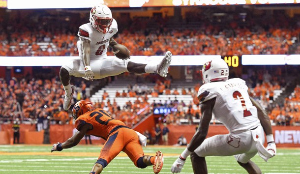 Sep 9, 2016; Syracuse, NY, USA; Louisville Cardinals quarterback Lamar Jackson (8) leaps over Syracuse Orange defensive back Cordell Hudson (20) during the second quarter at the Carrier Dome. Photo Credit: Rich Barnes-USA TODAY Sports