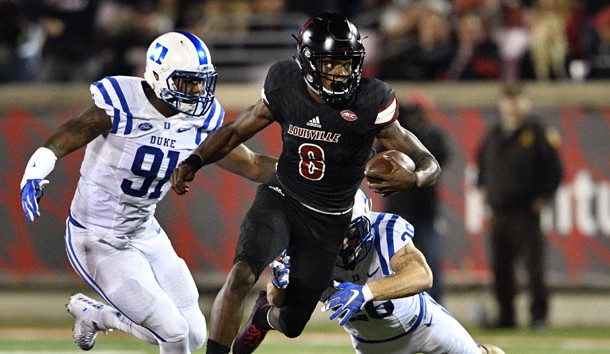 Oct 14, 2016; Louisville, KY, USA;  Louisville Cardinals quarterback Lamar Jackson (8) out runs the tackles of Duke Blue Devils safety Corbin McCarthy (26) and defensive end Marquies Price (91) during the second half at Papa John's Cardinal Stadium. Louisville defeated Duke 24-14.  Photo Credit: Jamie Rhodes-USA TODAY Sports