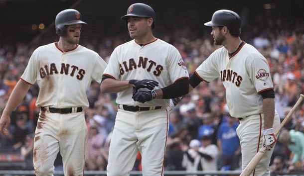 Oct 2, 2016; San Francisco, CA, USA;  San Francisco Giants starting pitcher Matt Moore (45) and third baseman Conor Gillaspie (21) and first baseman Brandon Belt (9) celebrate behind home plate against the Los Angeles Dodgers during the second inning at AT&T Park. Photo Credit: Neville E. Guard-USA TODAY Sports