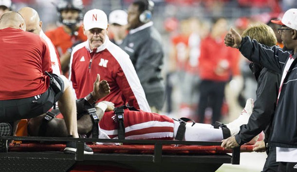 Nov 5, 2016; Columbus, OH, USA; Nebraska Cornhuskers quarterback Tommy Armstrong Jr. (4) and his father Tommy Armstrong Sr give each other a thumbs-up as he is taken off the field to a waiting ambulance after an injury in the second quarter against the Ohio State Buckeyes at Ohio Stadium. Mandatory Credit: Greg Bartram-USA TODAY Sports