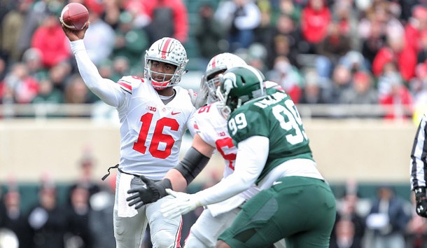 Nov 19, 2016; East Lansing, MI, USA; Ohio State Buckeyes quarterback J.T. Barrett (16) throws the ball against the Michigan State Spartans during the first quarter of a game at Spartan Stadium. Photo Credit: Mike Carter-USA TODAY Sports