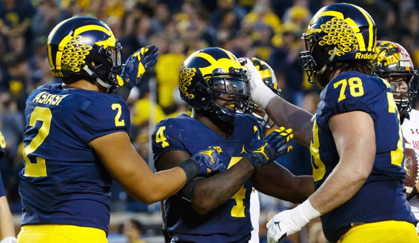 Nov 5, 2016; Ann Arbor, MI, USA; Michigan Wolverines running back De'Veon Smith (4) receives congratulations from tight end Devin Asiasi (2) and offensive lineman Erik Magnuson (78) after scoring a touchdown in the second half against the Maryland Terrapins at Michigan Stadium. Michigan 59-3. Photo Credit: Rick Osentoski-USA TODAY Sports