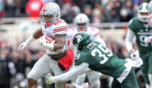 Nov 19, 2016; East Lansing, MI, USA; Ohio State Buckeyes running back Mike Weber (25) carries the ball as Michigan State Spartans wide receiver Justin Layne (39) defends during the first quarter at Spartan Stadium. Photo Credit: Mike Carter-USA TODAY Sports
