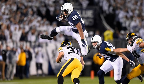 Nov 5, 2016; University Park, PA, USA; Penn State Nittany Lions running back Saquon Barkley (26) leaps over Iowa Hawkeyes defensive back Brandon Snyder (37) during the first quarter at Beaver Stadium. Photo Credit: Rich Barnes-USA TODAY Sports