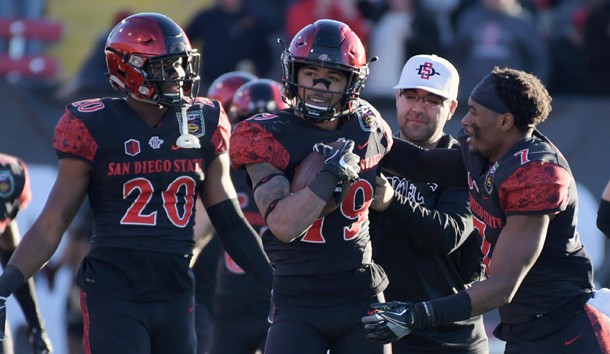 Dec 17, 2016; Las Vegas, NV, USA; San Diego State Aztecs running back Donnel Pumphrey (19) celebrates with running back Rashaad Penny (20) and safety Kameron Kelly (7) a 15-yard run in the fourth quarter to break the FBS career rushing record during the 25th Las Vegas Bowl against the Houston Cougars at Sam Boyd Stadium. Pumphrey finished with 115 yards, giving him 6,405 for his career. San Diego State defeated Houston 34-10. Photo Credit: Kirby Lee-USA TODAY Sports