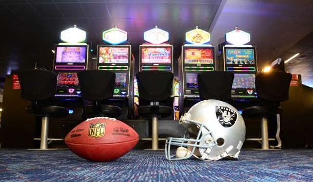 May 11, 2016; Las Vegas, NV, USA; General view of Oakland Raiders helmet and and NFL Wilson Duke football and slot machines at the McCarran International Airport. Raiders owner Mark Davis (not pictured) has pledged $500 million toward building a 65,000-seat domed stadium in Las Vegas at a total cost of $1.4 billion. Photo Credit: Kirby Lee-USA TODAY Sports