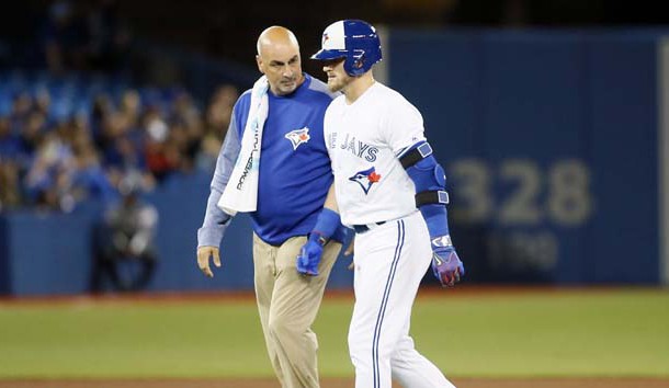 Apr 13, 2017; Toronto, Ontario, CAN; Toronto Blue Jays designated hitter Josh Donaldson (20) walks off the field with trainer George Poulis after hitting an rbi double in the sixth inning against the Baltimore Orioles at Rogers Centre. Photo Credit: John E. Sokolowski-USA TODAY Sports