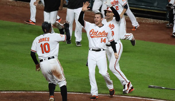 May 9, 2017; Baltimore, MD, USA; Baltimore Orioles outfielder Adam Jones (10) is greeted by teammates after scoring the game winning run in the 12th inning against the Washington Nationals at Oriole Park at Camden Yards. Photo Credit: Mitch Stringer-USA TODAY Sports
