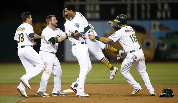 Jun 15, 2017; Oakland, CA, USA Oakland Athletics outfielder Khris Davis (2) is congratulated by teammates after hitting a two run single to win the game against the New York Yankees in the tenth inning at Oakland Coliseum. Photo Credit: Cary Edmondson-USA TODAY Sports