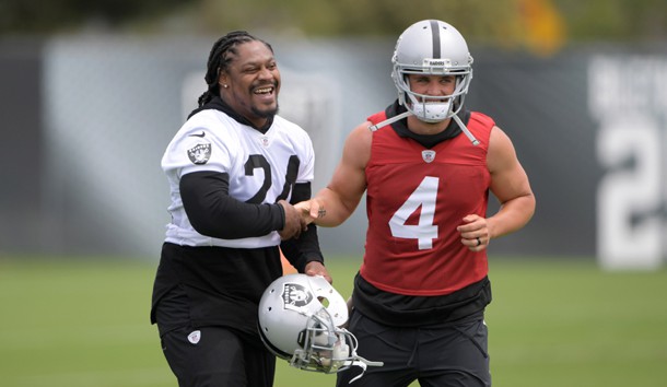 May 30, 2017; Alameda, CA, USA; Oakland Raiders running back Marshawn Lynch (24) and quarterback Derek Carr (4) react at organized team activities at the Raiders practice facility. Photo Credit: Kirby Lee-USA TODAY Sports