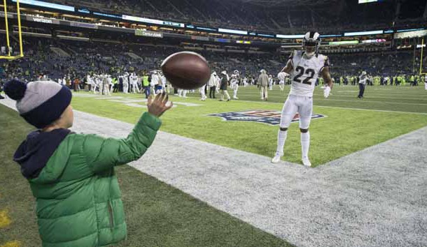 Dec 15, 2016; Seattle, WA, USA; Los Angeles Rams cornerback Trumaine Johnson (22) plays catch with a young Seattle Seahawks fan at CenturyLink Field. Photo Credit: Troy Wayrynen-USA TODAY Sports