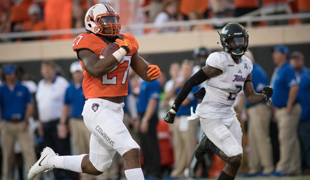 Aug 31, 2017; Stillwater, OK, USA; Oklahoma State Cowboys running back J.D. King (27) runs the ball for a touchdown, defended by Tulsa Golden Hurricane cornerback Kerwin Thomas (2) during the first half at Boone Pickens Stadium. Photo Credit: Rob Ferguson-USA TODAY Sports