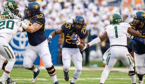 Dec 3, 2016; Morgantown, WV, USA; West Virginia Mountaineers running back Justin Crawford (25) runs the ball during the first quarter against the Baylor Bears at Milan Puskar Stadium. Photo Credit: Ben Queen-USA TODAY Sports