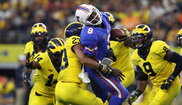 Sep 2, 2017; Arlington, TX, USA; Florida Gators quarterback Malik Zaire (8) is tackled on a run by Michigan Wolverines cornerback Lavert Hill (23) at AT&T Stadium. Photo Credit: Matthew Emmons-USA TODAY Sports