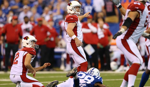 Sep 17, 2017; Indianapolis, IN, USA; Arizona Cardinals kicker Phil Dawson (4) kicks the game winning field goal under pressure from Indianapolis Colts cornerback Chris Milton (28) in the overtime quarter at Lucas Oil Stadium. At left is Arizona Cardinals holder Andy Lee (2) Photo Credit: Aaron Doster-USA TODAY Sports