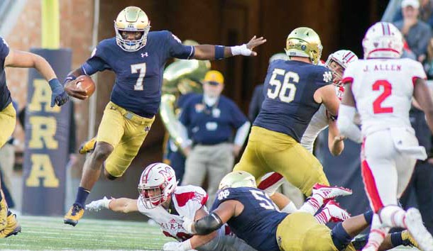 Sep 30, 2017; South Bend, IN, USA;Notre Dame Fighting Irish quarterback Brandon Wimbush (7) runs with the abll while Miami (Oh) Redhawks linebacker Brad Koenig (38) defends in the first half of the game at Notre Dame Stadium. Photo Credit: Trevor Ruszkowski-USA TODAY Sports