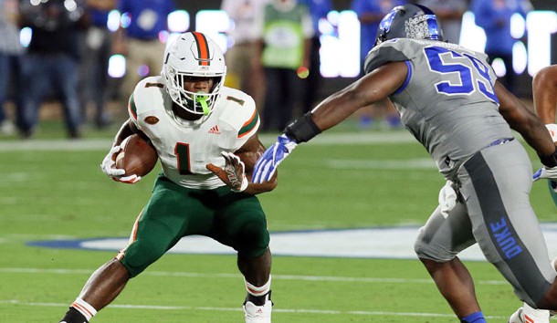 Sep 29, 2017; Durham, NC, USA; Miami Hurricanes running back Mark Walton (1) looks for running room against Duke Blue Devils defensive end Tre Hornbuckle (59) in the first half at Wallace Wade Stadium. Photo Credit: Mark Dolejs-USA TODAY Sports