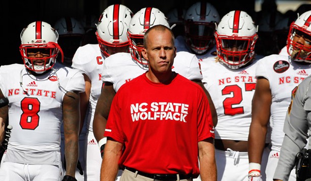 Oct 14, 2017; Pittsburgh, PA, USA;  North Carolina State Wolfpack head coach Dave Doeren (middle) leads his team from the tunnel to play the Pittsburgh Panthers at Heinz Field. The Wolfpack won 35-17. Photo Credit: Charles LeClaire-USA TODAY Sports