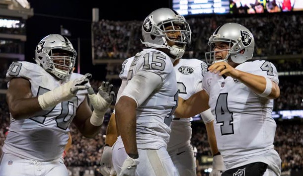 Oct 19, 2017; Oakland, CA, USA; Oakland Raiders wide receiver Michael Crabtree (15) celebrates with quarterback Derek Carr (4) after scoring the game tying touchdown against the Kansas City Chiefs during the fourth quarter at Oakland Coliseum. Photo Credit: Kelley L Cox-USA TODAY Sports