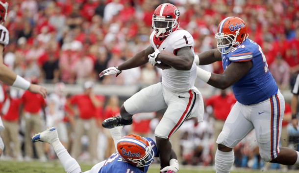 Oct 28, 2017; Jacksonville, FL, USA; Florida Gators linebacker Vosean Joseph (11) and Florida Gators defensive lineman Khairi Clark (54) tackle Georgia Bulldogs running back Sony Michel (1)  during the first quarter at EverBank Field. Photo Credit: Kim Klement-USA TODAY Sports