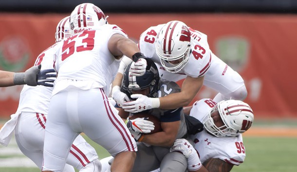 Oct 28, 2017; Champaign, IL, USA; Illinois Fighting Illini running back Kendrick Foster (22) is tackled by Wisconsin Badgers linebacker Ryan Connelly (43) and  nose tackle Olive Sagapolu (99) during the fourth quarter at Memorial Stadium. Photo Credit: Mike Granse-USA TODAY Sports