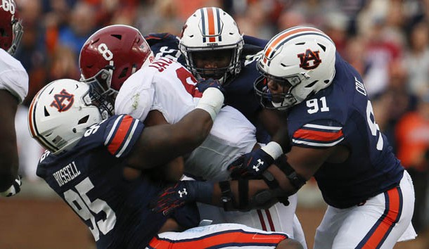 Nov 25, 2017; Auburn, AL, USA; Alabama Crimson Tide running back Josh Jacobs (8) is brought down by Auburn Tigers defensive lineman Dontavius Russell (95) and defensive lineman Nick Coe (91) during the second quarter at Jordan-Hare Stadium. Photo Credit: John Reed-USA TODAY Sports