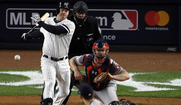 Oct 16, 2017; Bronx, NY, USA; New York Yankees third baseman Chase Headley (12) hits an RBI single during the fourth inning during game three of the 2017 ALCS playoff baseball series at Yankee Stadium. Photo Credit: Adam Hunger-USA TODAY Sports