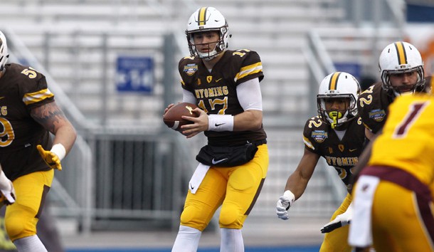 Dec 22, 2017; Boise, ID, USA; Wyoming Cowboys quarterback Josh Allen (17) takes the snap  from center during the first half of the 2017 Potato Bowl versus Central Michigan Chippewas at Albertsons Stadium. Photo Credit: Brian Losness-USA TODAY Sports