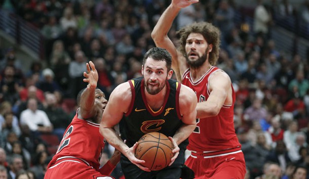 Dec 4, 2017; Chicago, IL, USA; Cleveland Cavaliers forward Kevin Love (0) goes to the basket between Chicago Bulls guard Kris Dunn (32) and center Robin Lopez (42) during the second half at United Center. Photo Credit: Kamil Krzaczynski-USA TODAY Sports